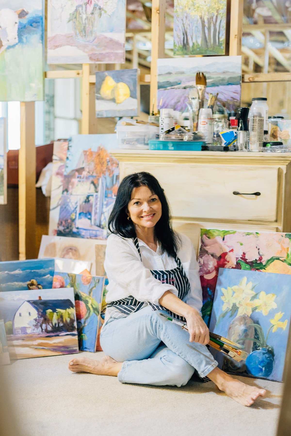 Summer Ray painting at her easel